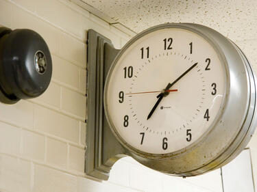 There is a picture of an analog clock on the wall.